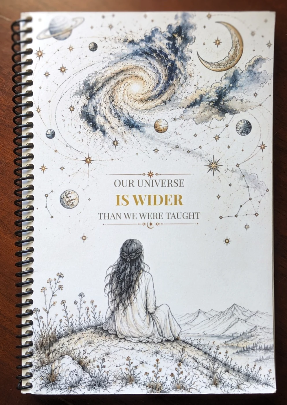 Front cover of Our Universe Is Wider Than We Were Taught, a spiral-bound journal by Solace & Inkwell.